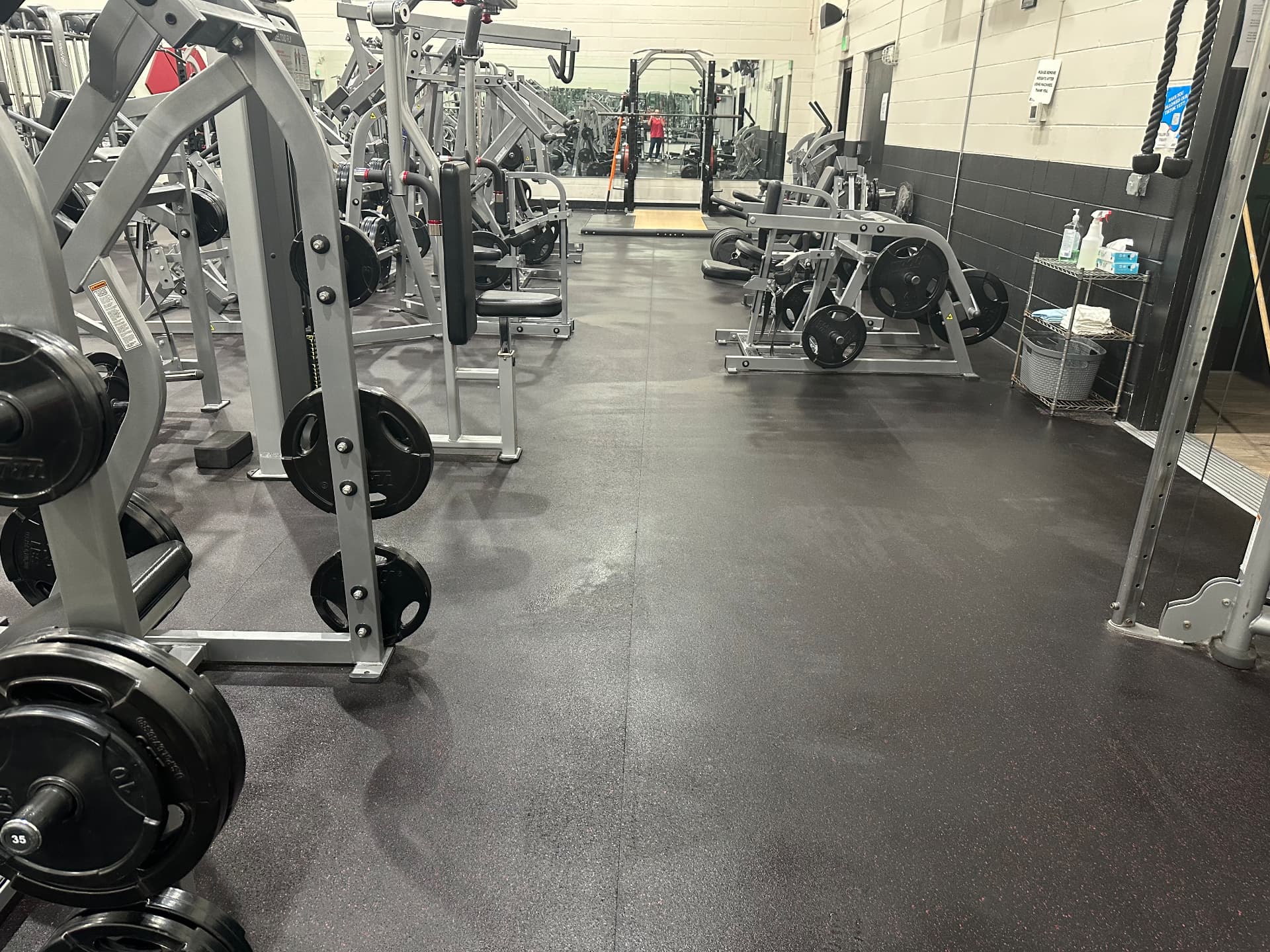 Weight room floors and equipment Gym weight room with rubber flooring scrubbed and strength equipment sanitized by Hello Clean & Company