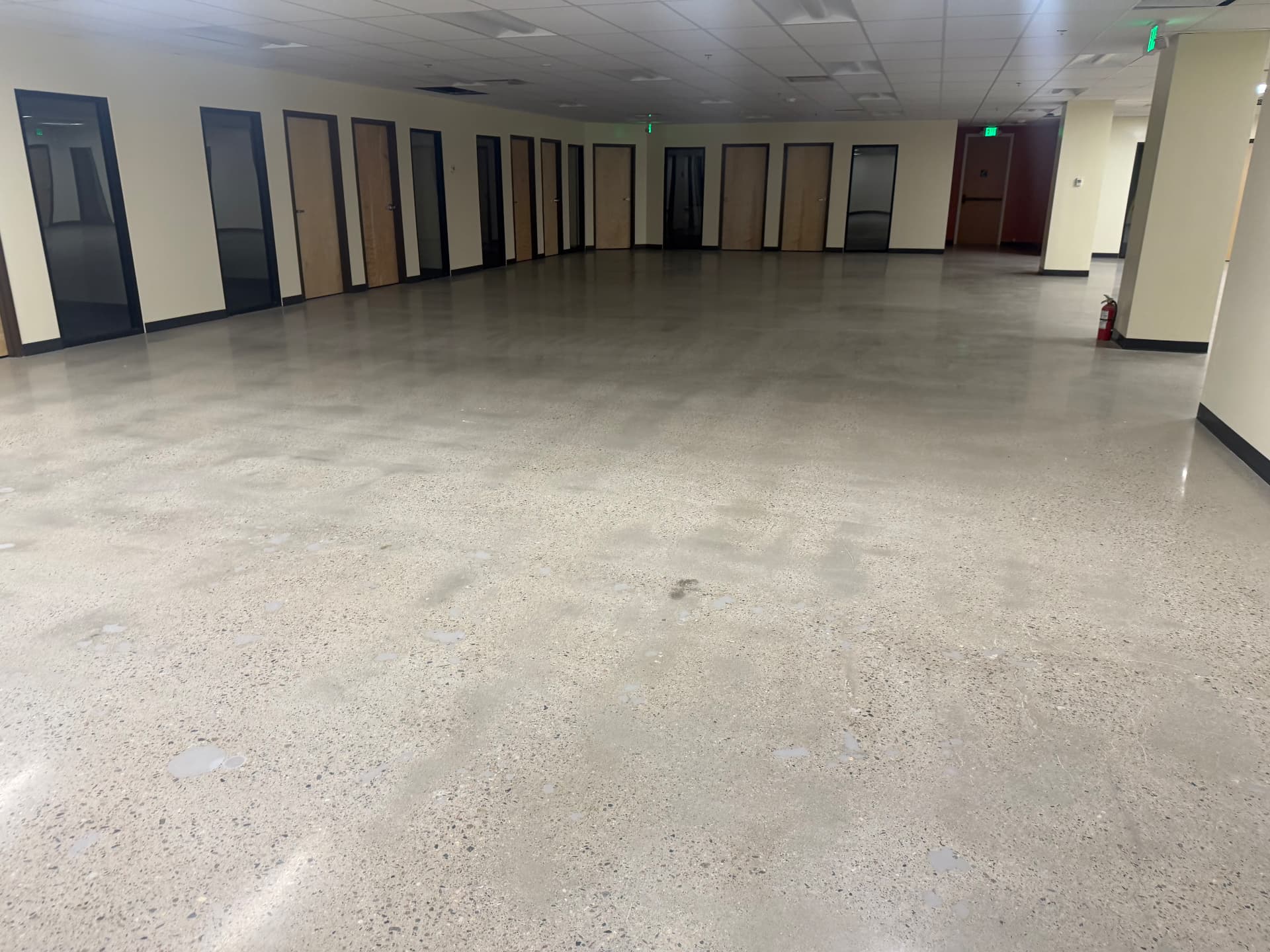 Large open commercial office floor with polished concrete cleaned after a tenant improvement build-out in Colorado