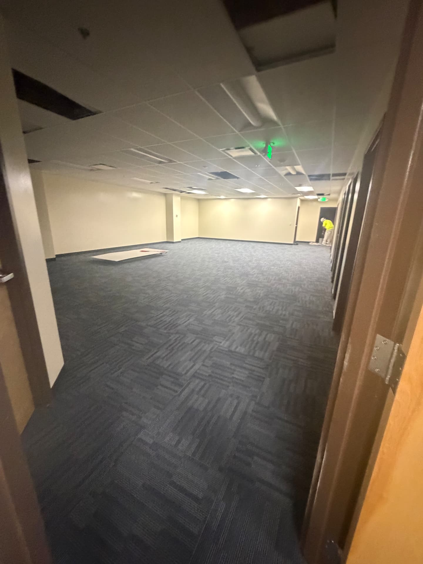 New commercial carpet tile vacuumed and dust extracted during a corporate office post-construction clean