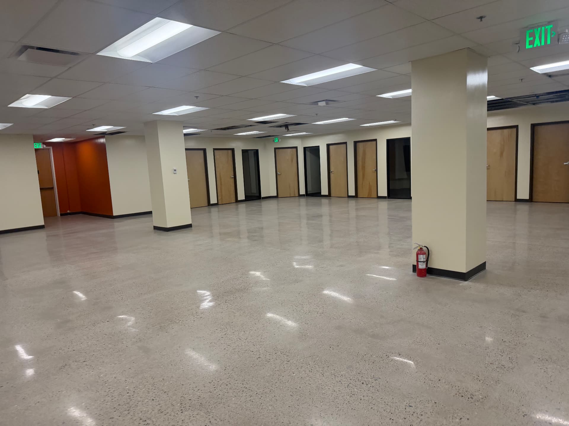 Open commercial office floor with columns and polished concrete after a final construction clean in Lakewood, CO