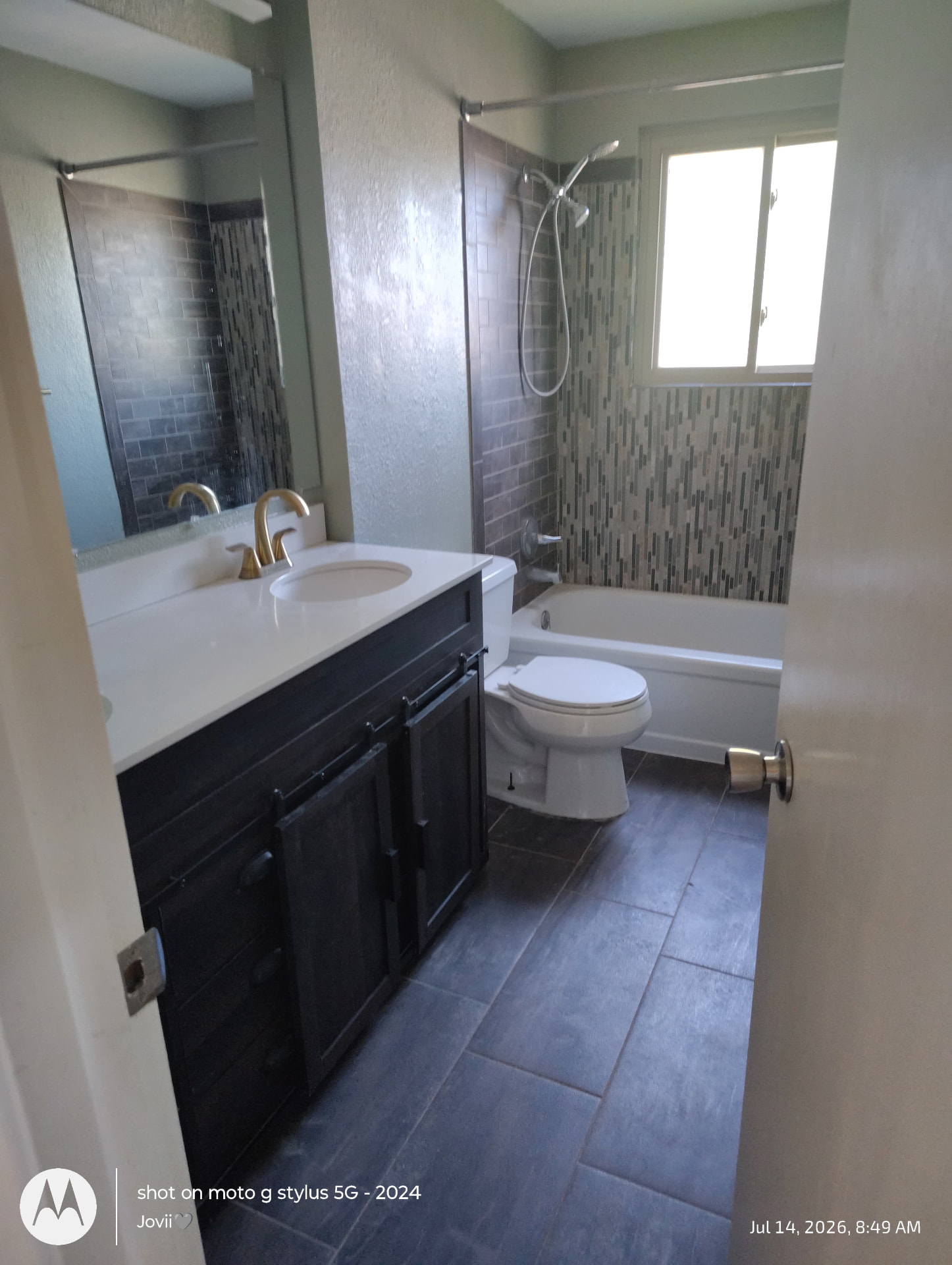 Bathroom deep clean, tub and tile Bathroom cleaned by Hello Clean & Company with scrubbed tile tub surround, vanity and tile floor
