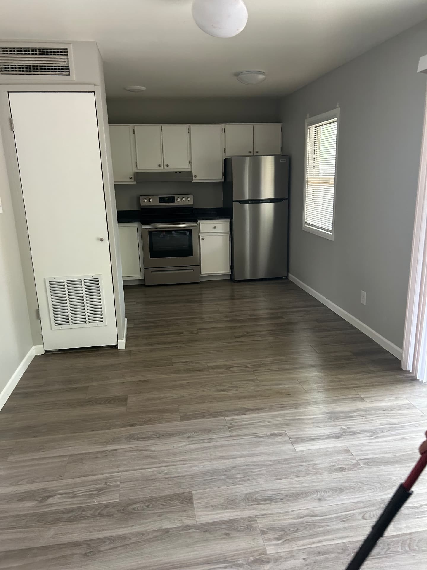 Vacant apartment kitchen with stainless range and refrigerator cleaned before new move-in