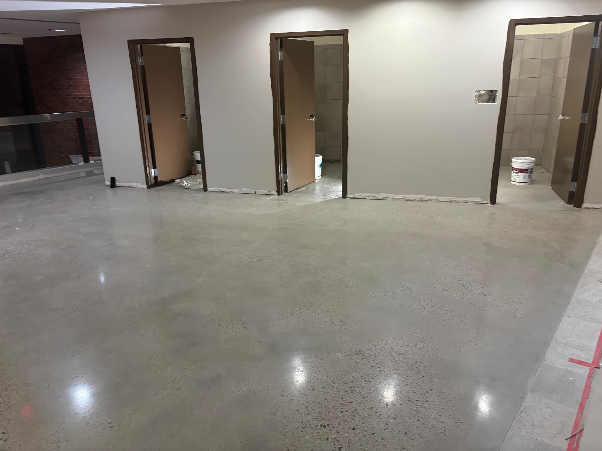 Commercial restroom concourse with tile and polished concrete cleaned after construction punch list work